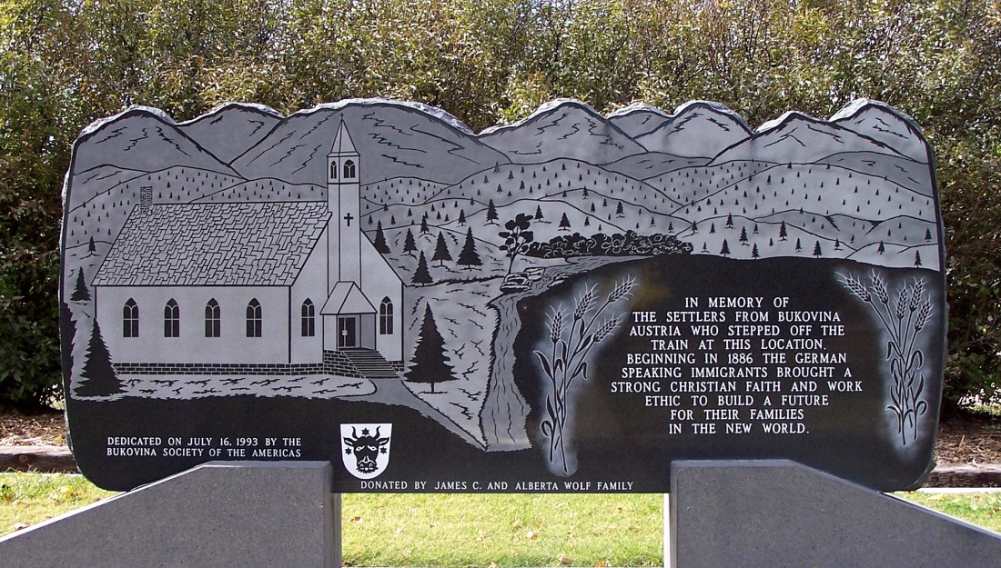 In Memory of the Settlers from Bukovina Austria Who Stepped off the Train at this Location.  Beginning in 1886 the German Speaking Immigrants Brought a Strong Christian Faith and Work Ethic to Build a Future for their Families in the New World.  Dedicated on July 16, 1993 by the Bukovina Society of the Americas.  Donated by James C. and Alberta Wolf Family.