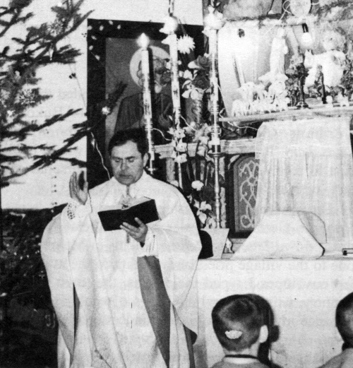 Fr. Cazimir Cotalenici in the church of Pojana Mikului saying Mass.