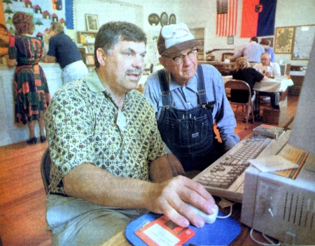 Werner Zoglauer, Naperville, Ill. left, helps Martin Flax, Ellis, trace his family history Saturday at the Bukovina Society of the Americas headquarters in Ellis, KS