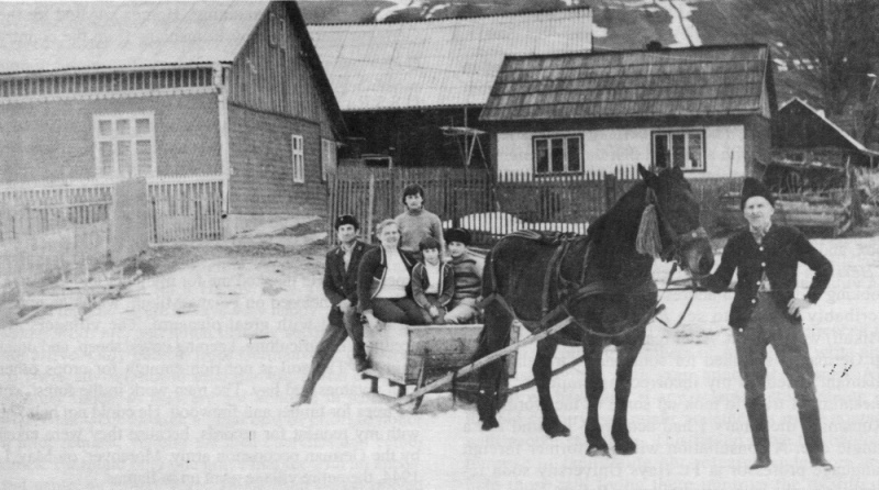 Left to right: Lukasz Balak (standing);  his wife and three children on the sleigh, his father holding horse in Pojana Mikului, 1990